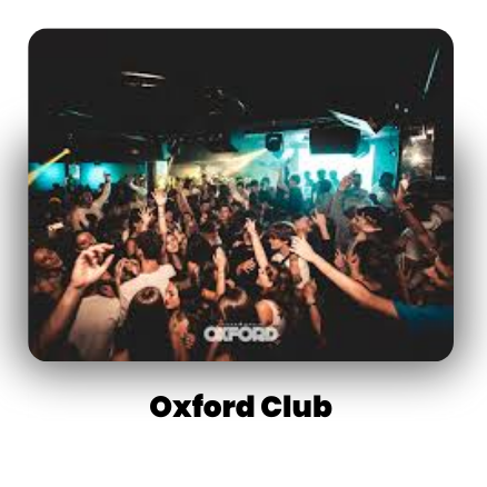 Crowded nightclub scene with people dancing energetically under colorful lights at Oxford Club.