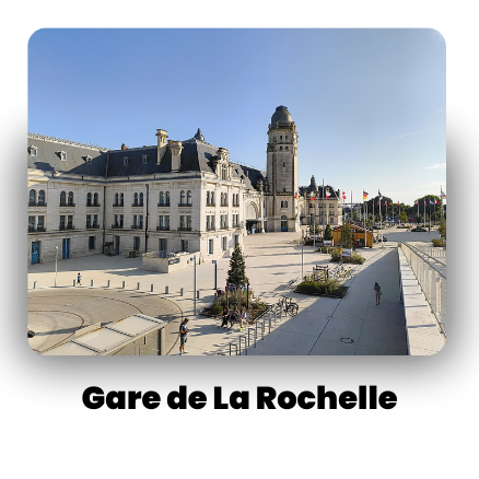 Historic Gare de La Rochelle with clock tower in open plaza under blue sky.