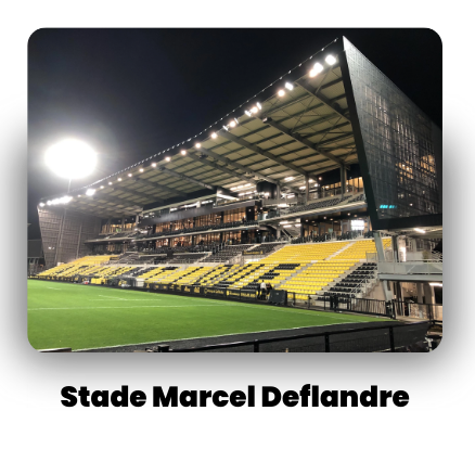 Stade Marcel Deflandre, sports stadium with illuminated seating and a covered stand.